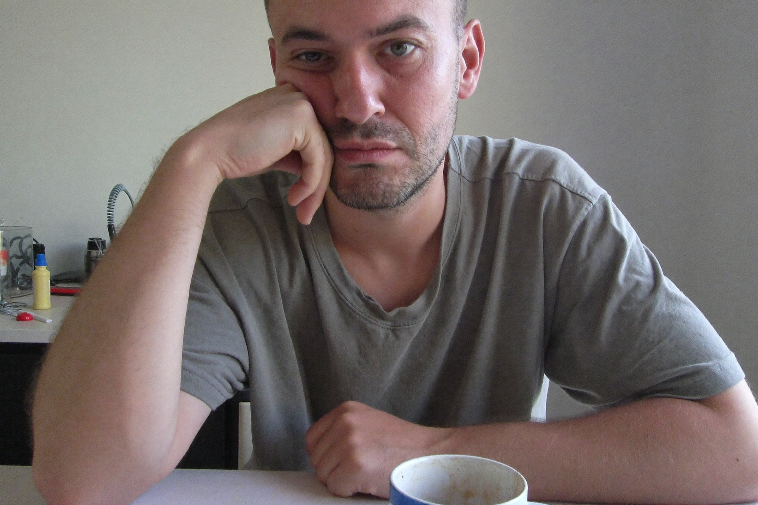 A tired man at a kitchen table